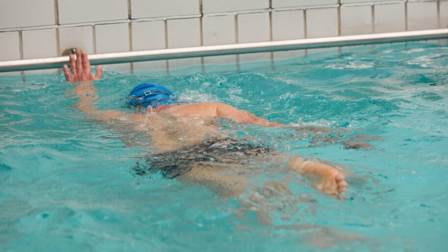 Swimmer practising his kicking