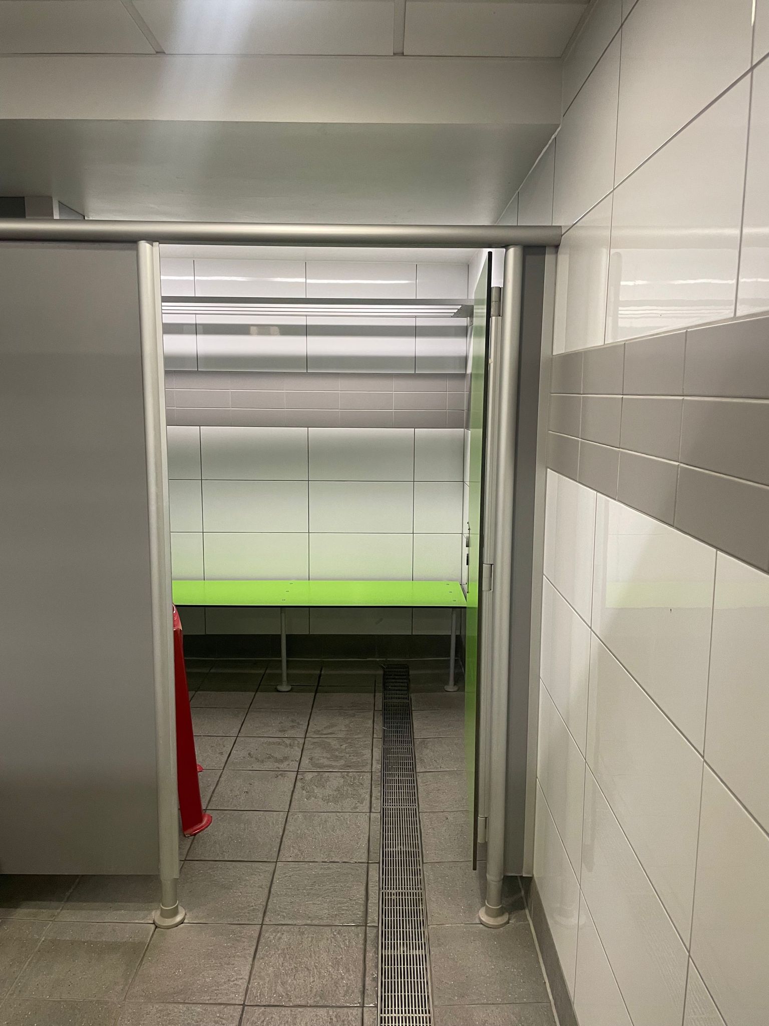 large changing cubicle with a bench