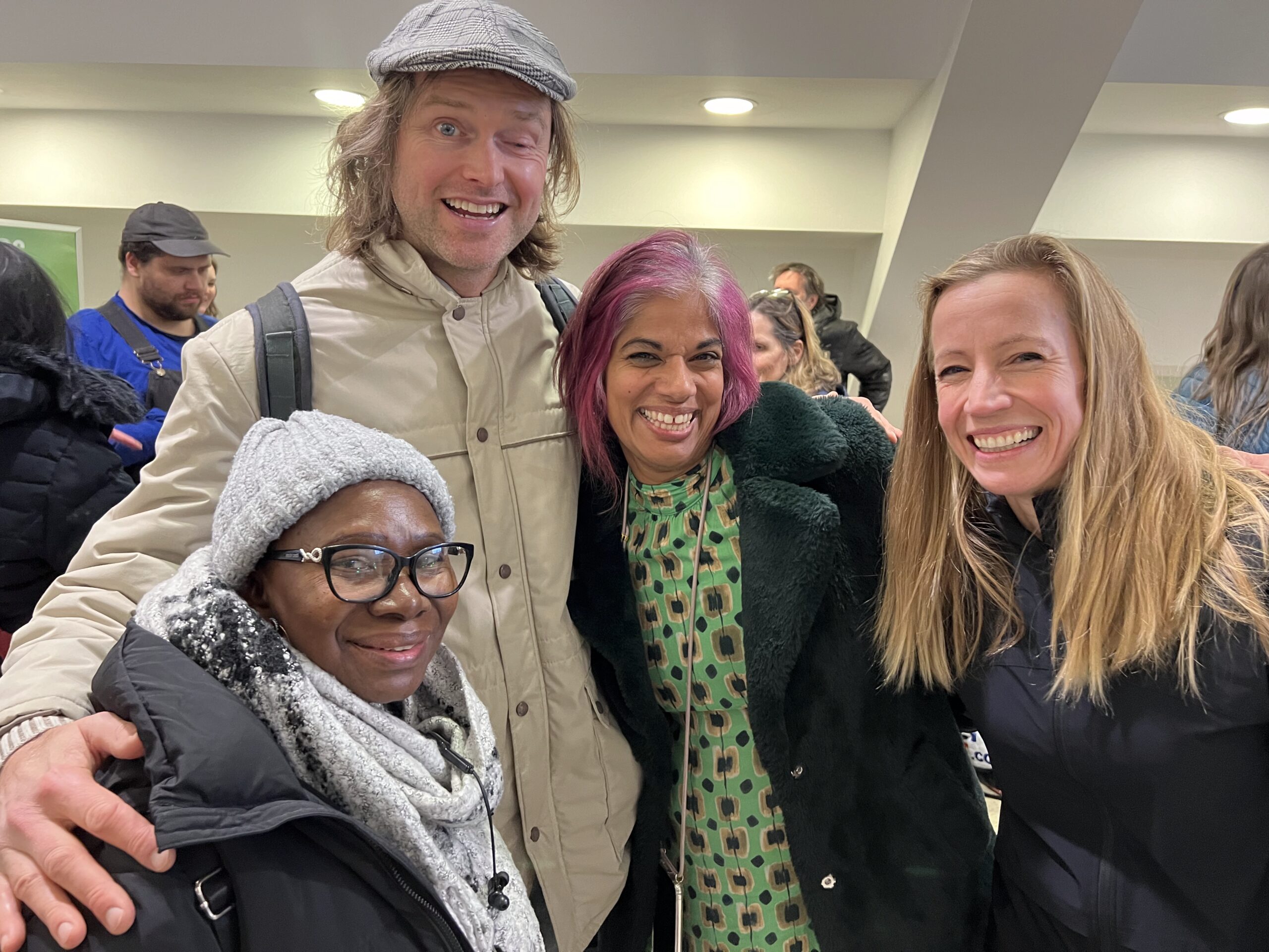 A group of swimmers and volunteers at WeSwim's 2024 gala. From left to right are Norlie (swimmer), Bob (swimmer), Rosanna (volunteer), and Tash (WeSwim founder). 